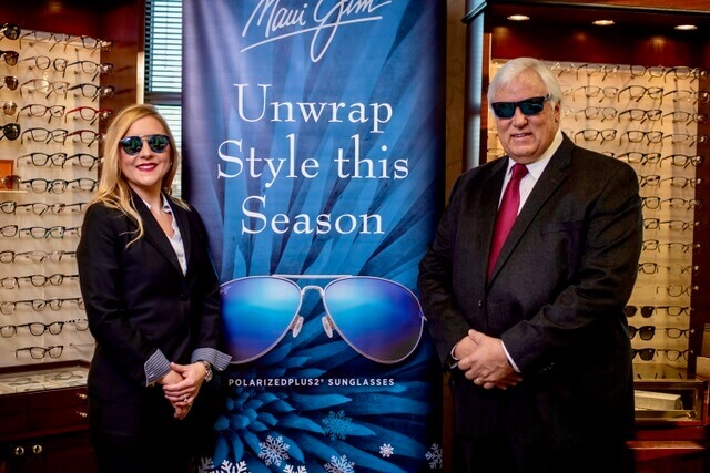 Doctors Standing in Front of a Sign That Says Unwrap Style This Season With Sunglasses On